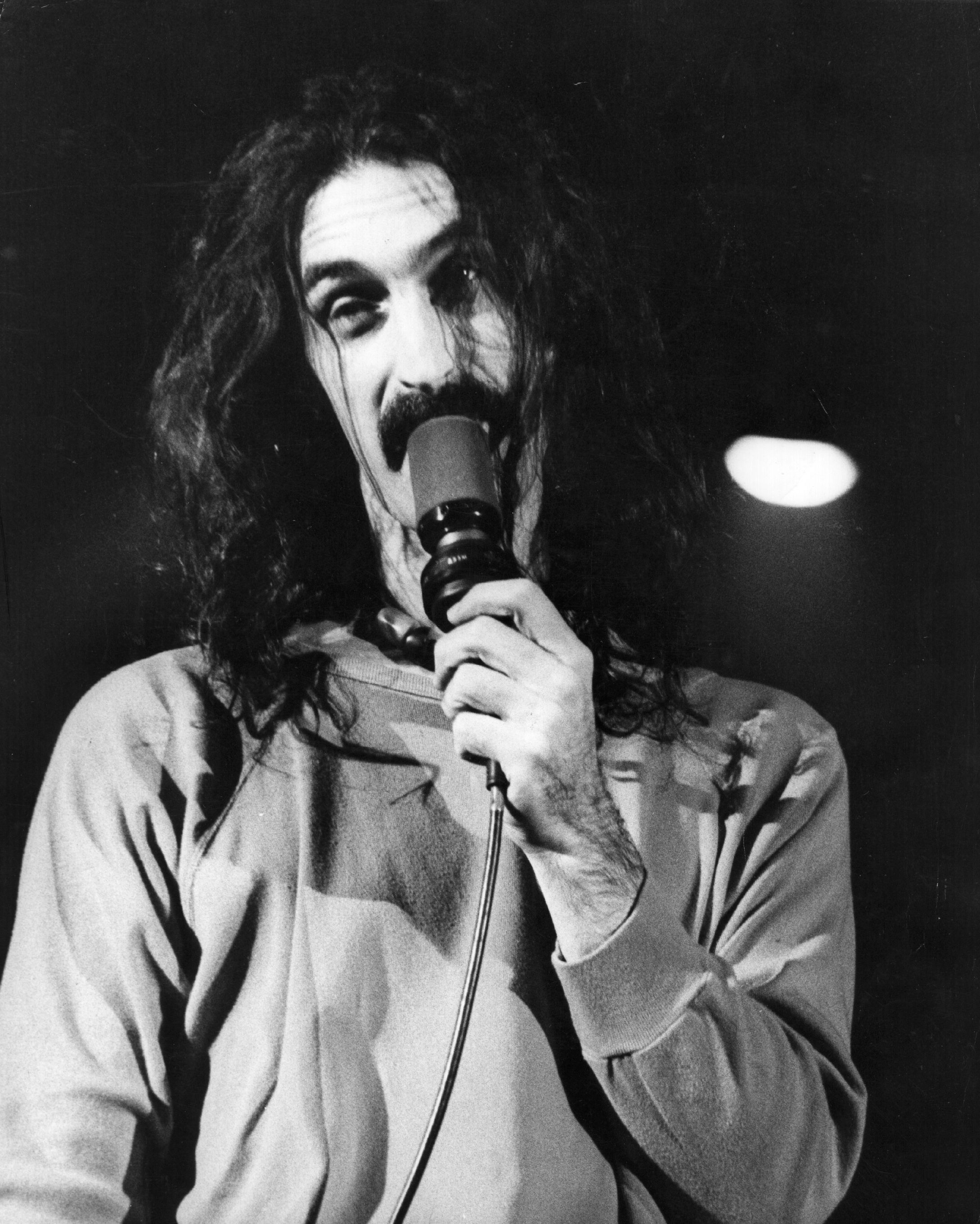American experimental rock singer, songwriter, guitarist and composer Frank Zappa (1940 - 1993), on stage at the Hammersmith Odeon, London. (Source: Getty Images)