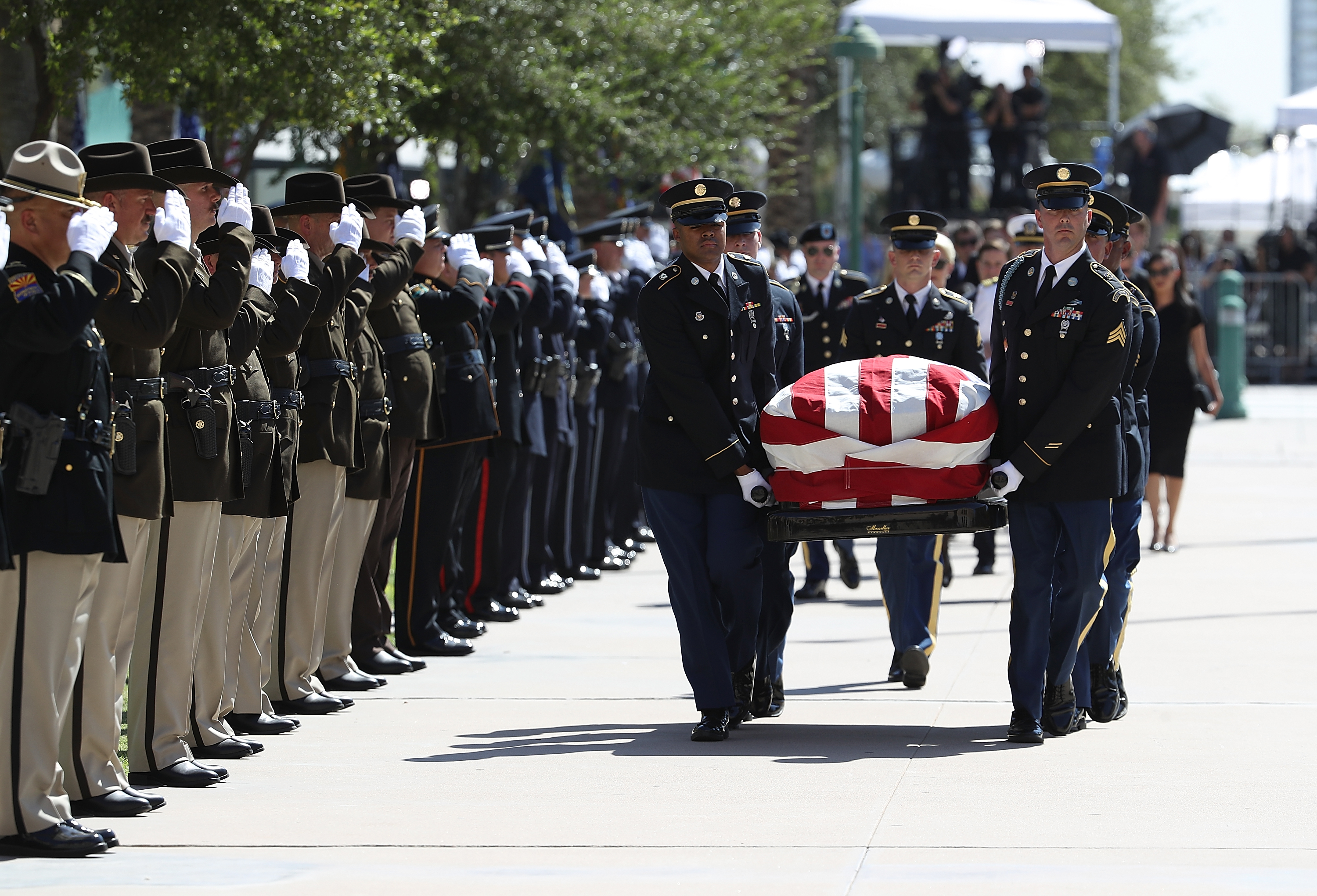 The casket of US Sen John McCain (R-AZ) is carried into the Arizona State Capitol on August 29, 2018 in Phoenix, Arizona. US Sen John McCain will lie in State at the Arizona State Capitol before being transported to Washington DC where he will be buried at the US Naval Academy Cemetery in Annapolis. Sen McCain, a decorated war hero, died August 25 at the age of 81 after a long battle with Glioblastoma, a form of brain cancer.
