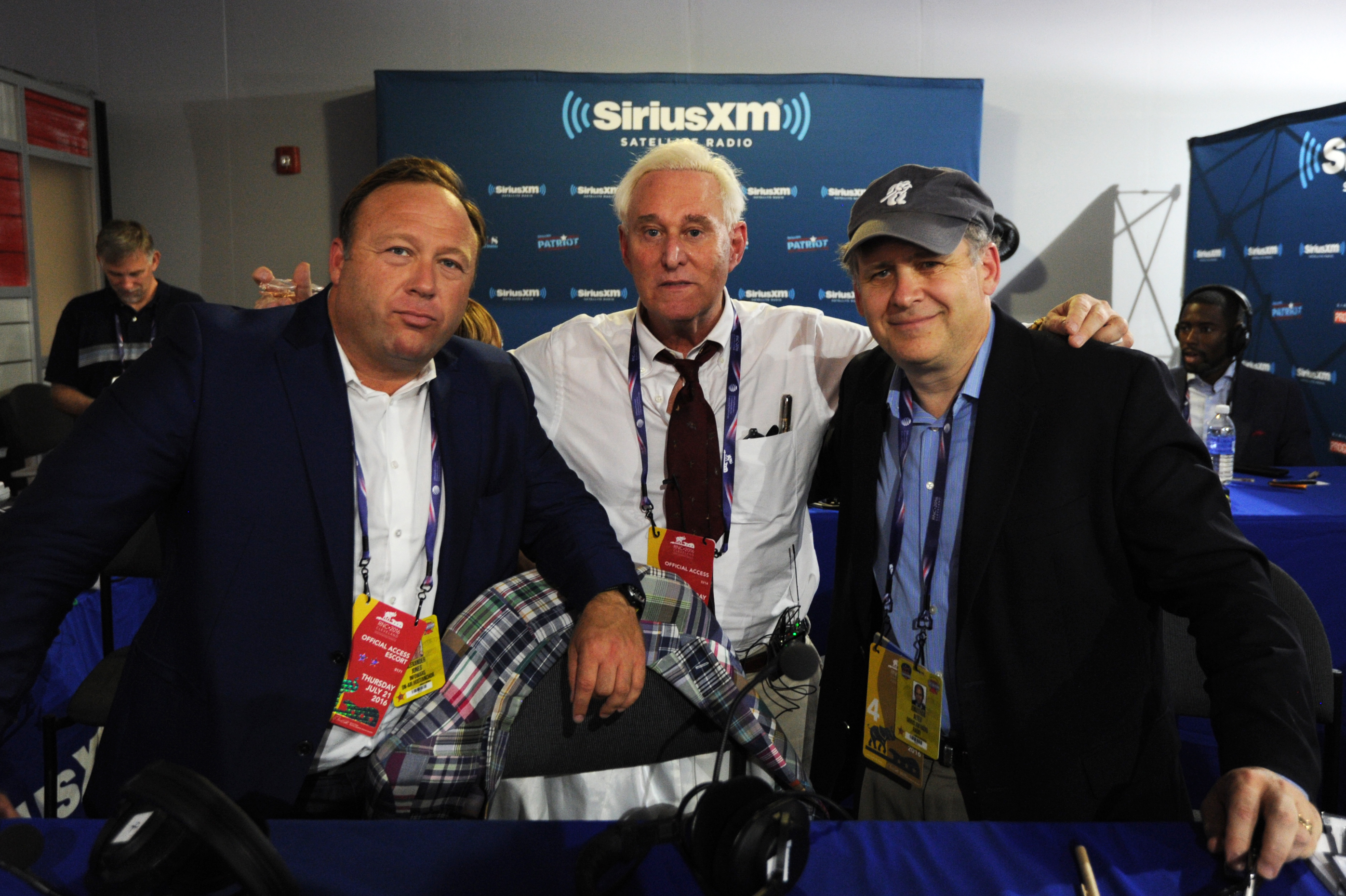 Alex Stone, of Infowars, Roger Stone, former Donald Trump advisor, and Jonathan Alter pose for a photo following an episode of Alter Family Politics on SiriusXM at Quicken Loans Arena on July 20, 2016 in Cleveland, Ohio.