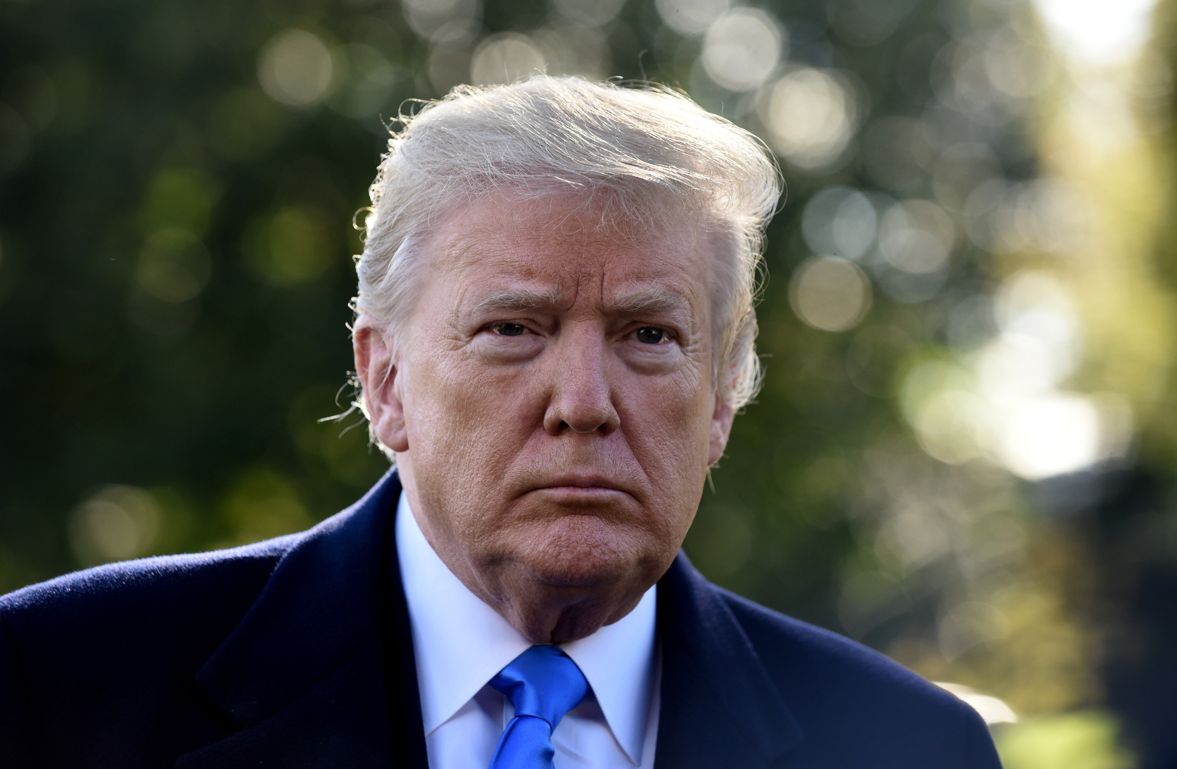 (AFP OUT) U.S. President Donald Trump speaks to reporters on the South Lawn before boarding Marine One at the White House on October 13, 2018 in Washington, DC. President Trump is traveling to a rally in Kentucky.