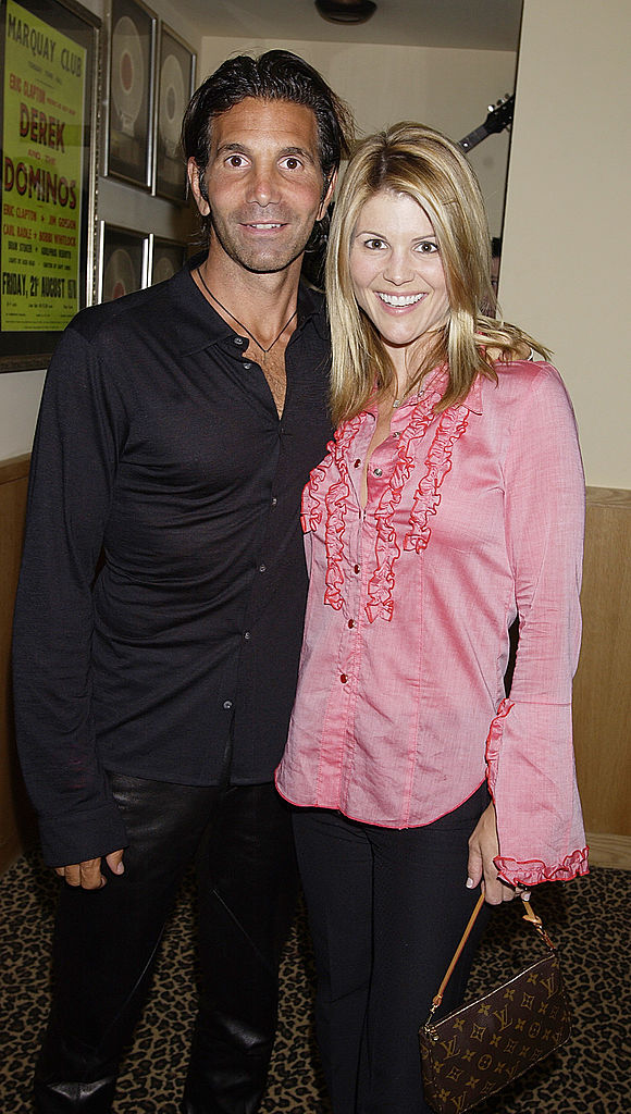 Actress Lori Laughlin and husband/designer Mossimo Giannulli arrive April 26, 2002, at the Hard Rock Hotel in Las Vegas, NV. (Source: Scott Harrison/Getty Images)