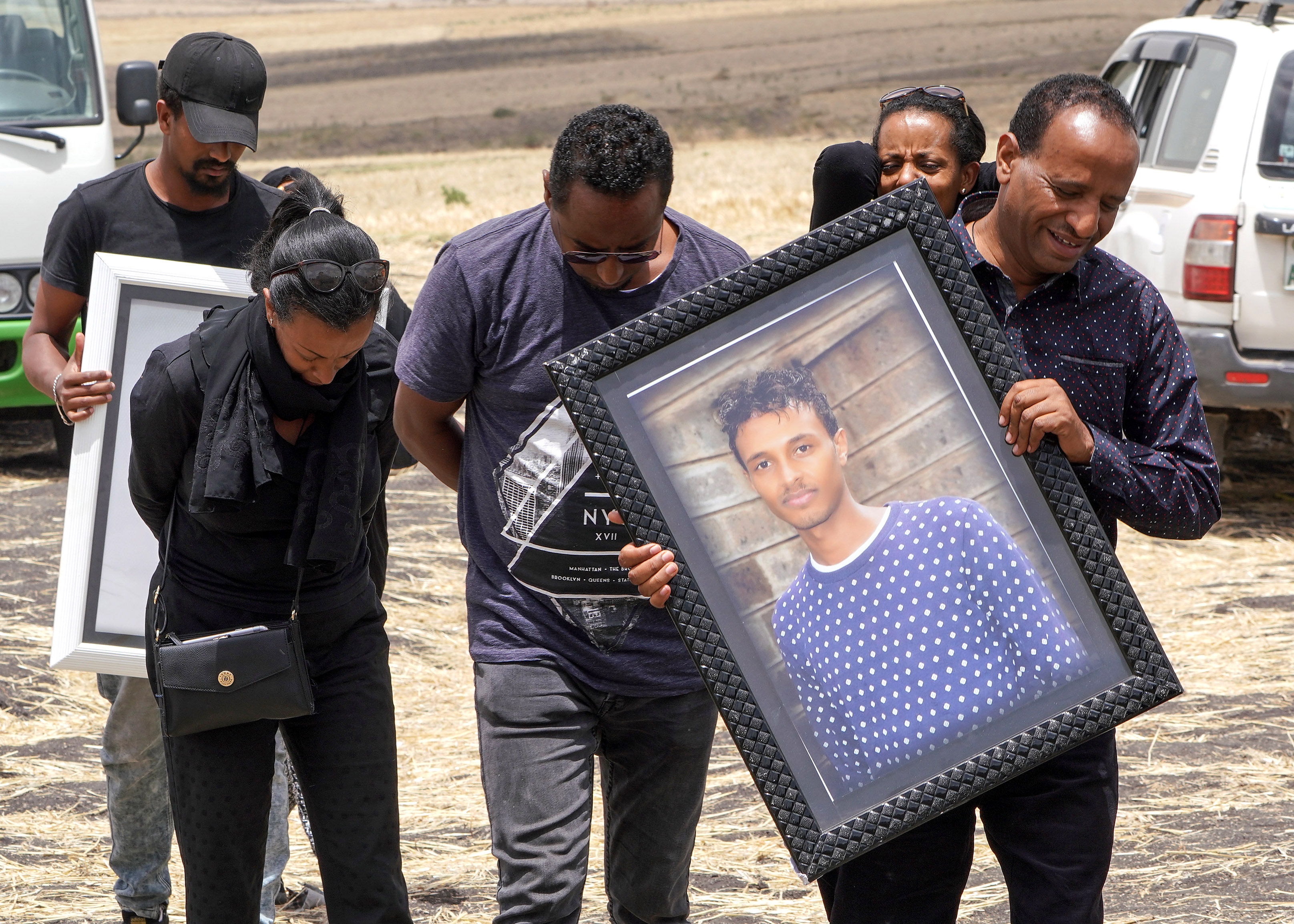 Family members of 28-year-old Captain Yared Getecho visit the crash site of Ethiopian Airlines Flight ET302 on March 14, 2019, in Ejere, Ethiopia. (Getty)