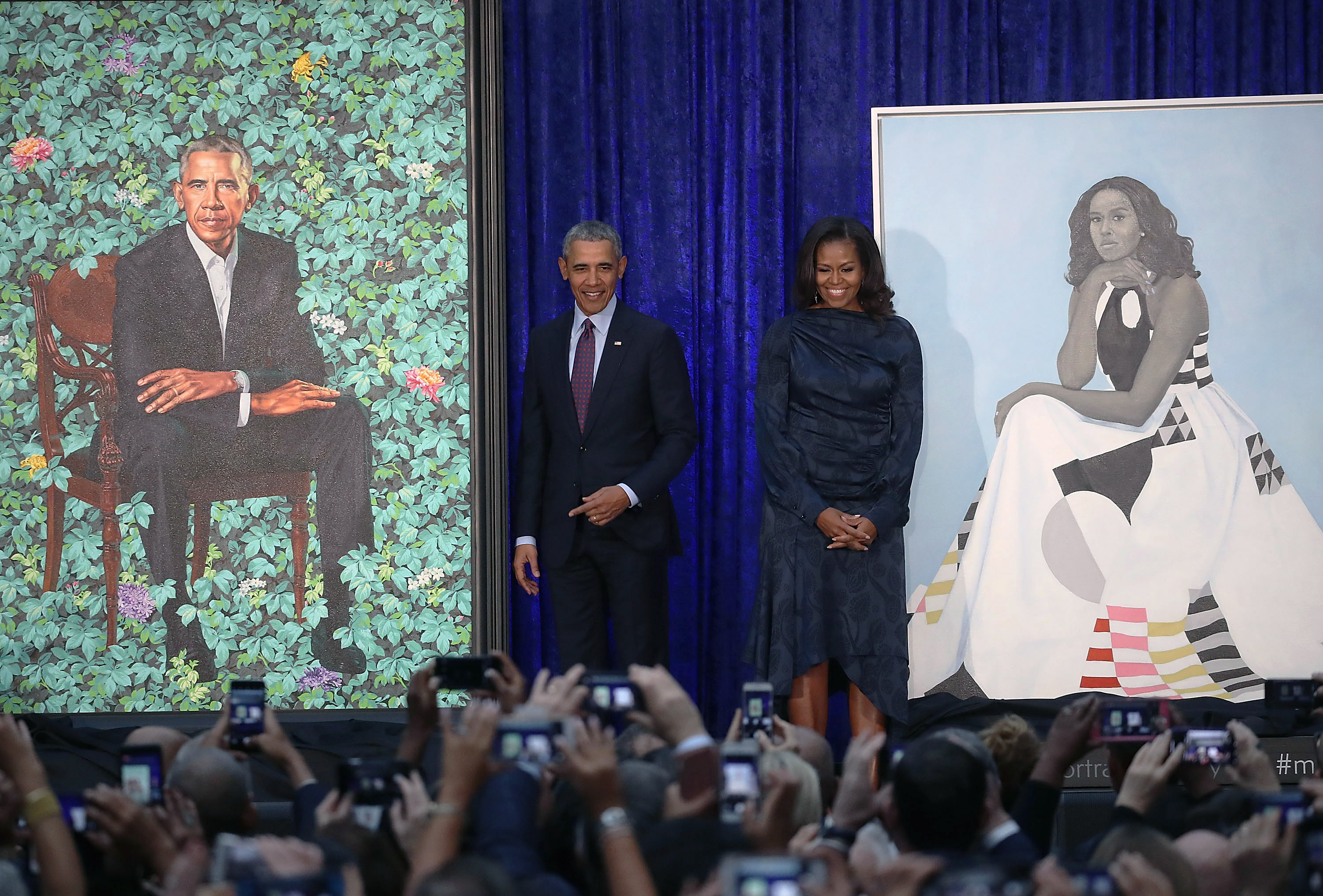 Former U.S. President Barack Obama and former first lady Michelle Obama stand next to their newly unveiled portraits during a ceremony at the Smithsonian's National Portrait Gallery, on February 12, 2018 in Washington, DC. The portraits were commissioned by the Gallery, for Kehinde Wiley to create President Obama's portrait, and Amy Sherald that of Michelle Obama (Getty Images)