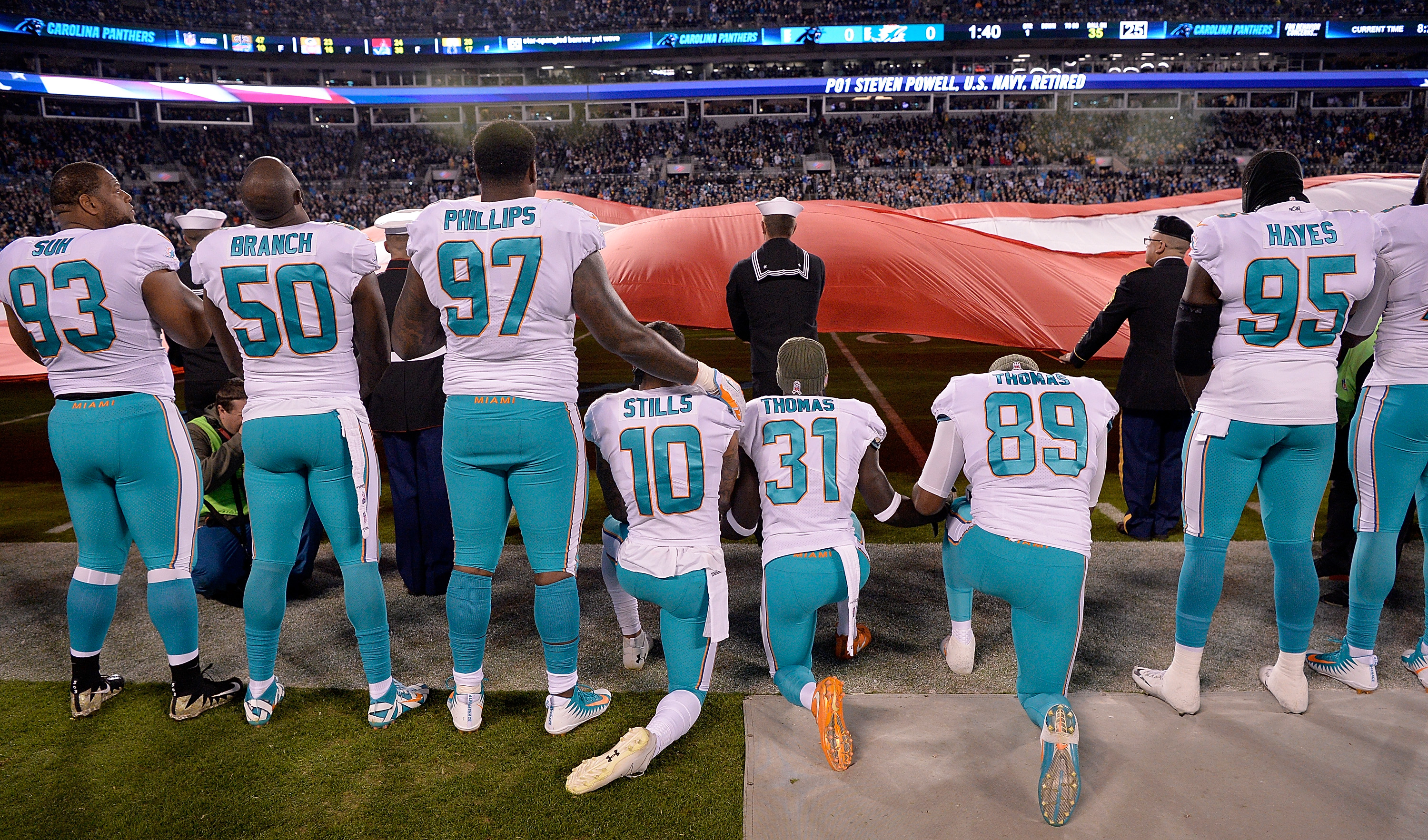 Miami Dolphins players kneel during the national anthem before their game against the Carolina Panthers at Bank of America Stadium on November 13, 2017 in Charlotte, North Carolina.
