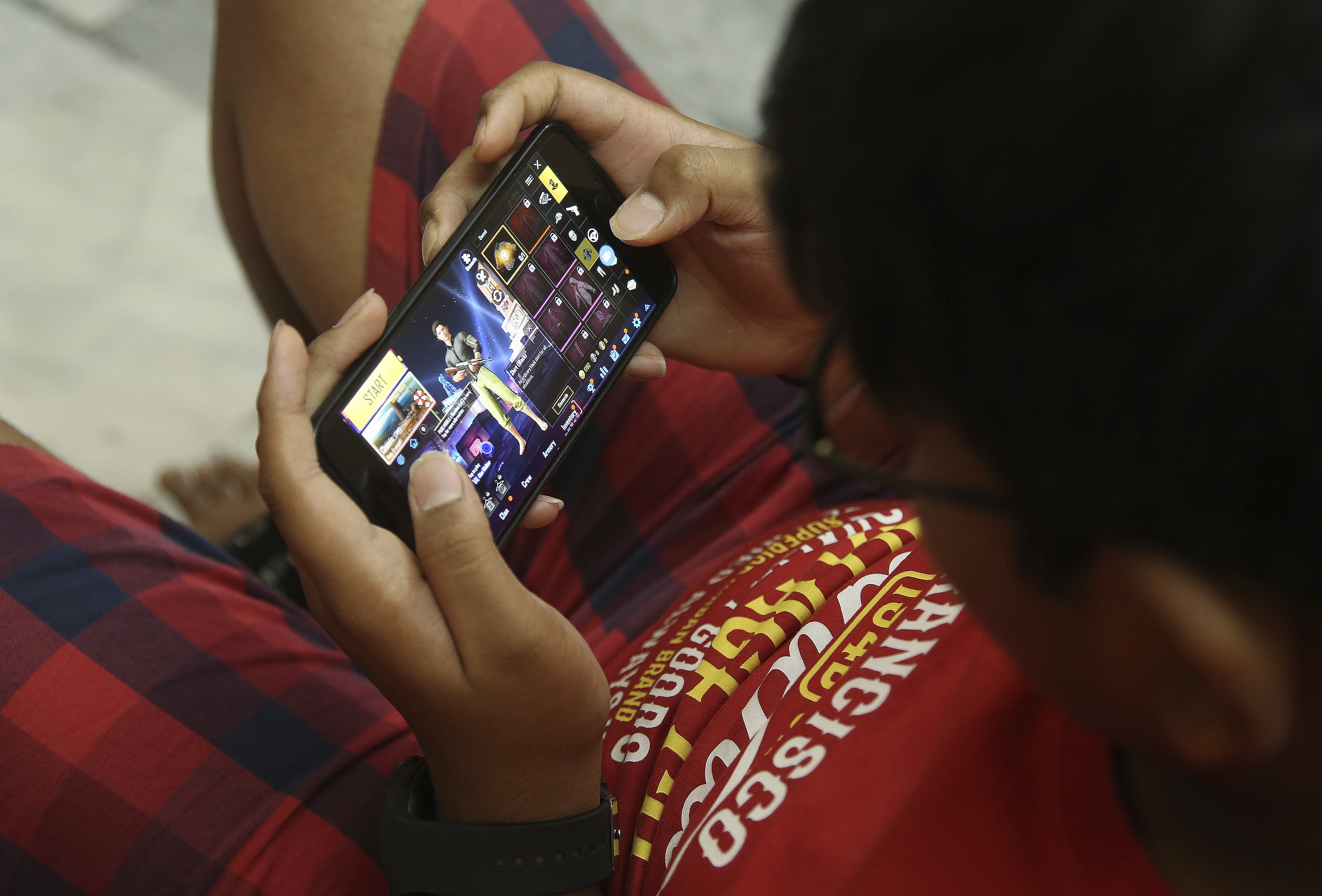 Indian children play online game PUBG on their mobile phones (AP Photo/ Mahesh Kumar A.)