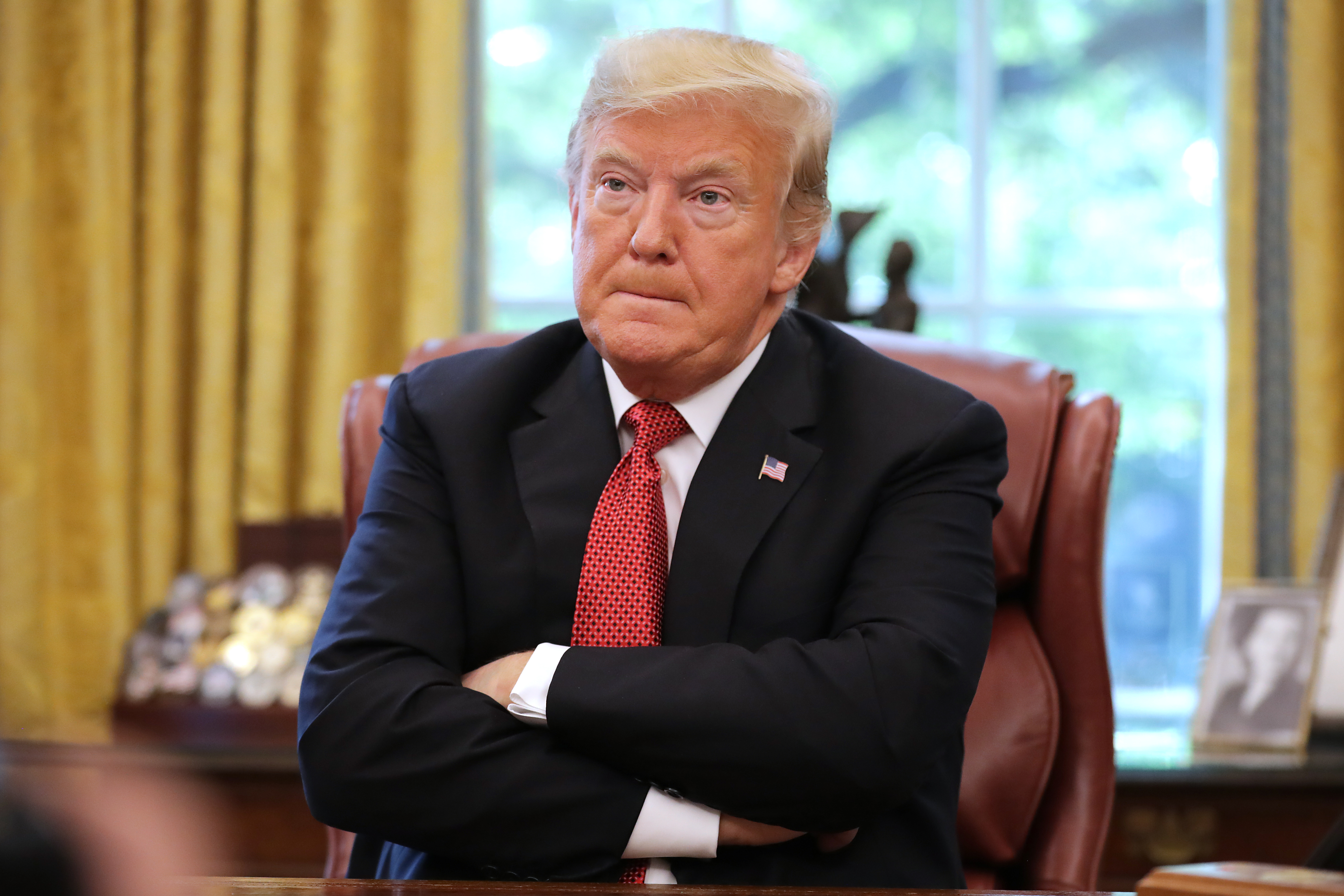 U.S. President Donald Trump talks to reporters while hosting workers and members of his cabinet for a meeting in the Oval Office at the White House October 17, 2018 in Washington, DC. The White House said the meeting was on “Cutting the Red Tape, Unleashing Economic Freedom.'
