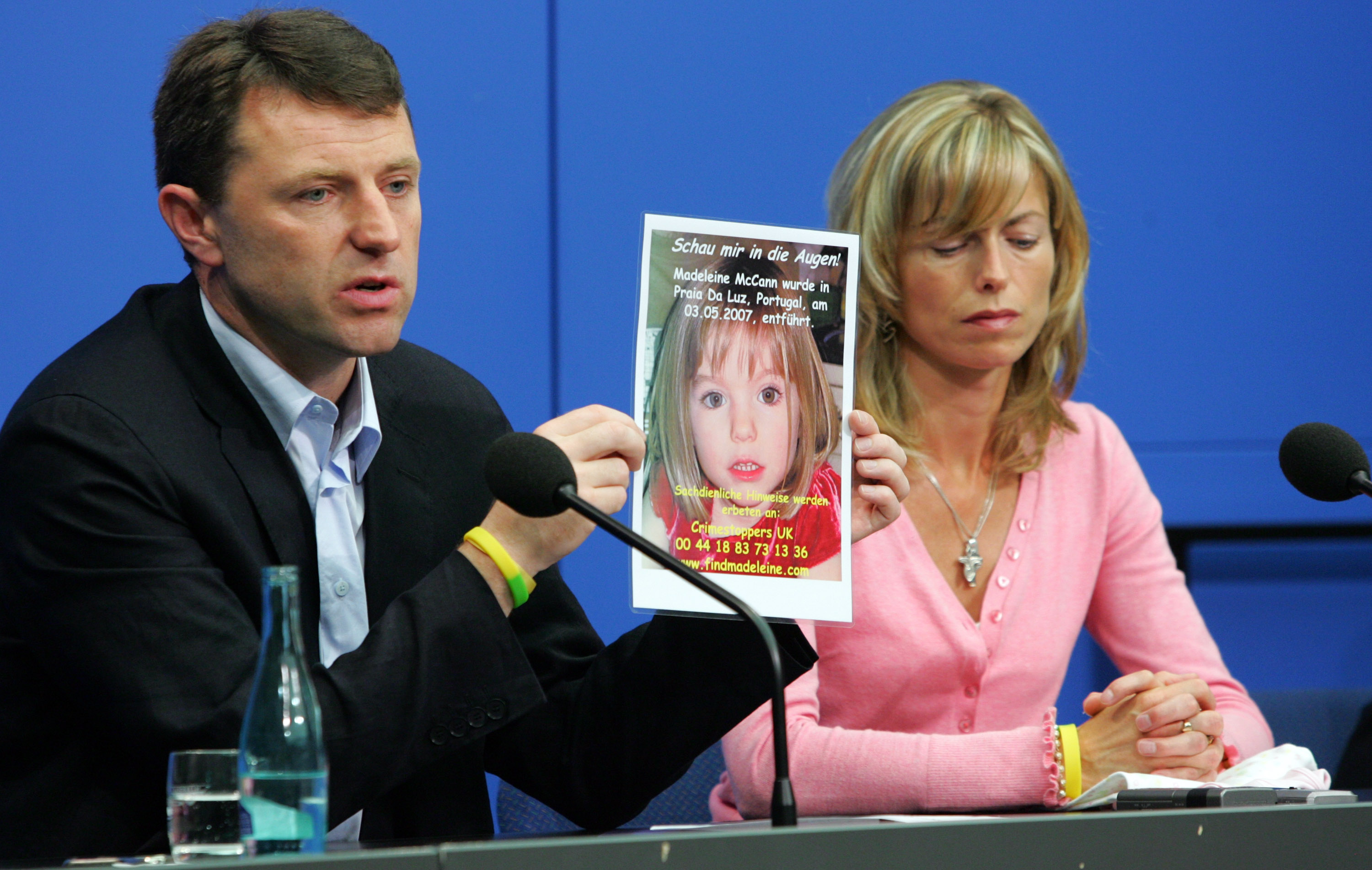 Kate and Gerry McCann, the parents of the missing four-year-old British girl Madeleine McCann, hold up a picture of Madeleine during a press conference on June 6, 2007, in Berlin, Germany. Kate and her husband Gerry are in Berlin to spread the word in the search for their missing duaghter Madeleine who disappeared from their holiday apartment in Praia da Luz, Portugal on May 3, 2007. (Getty Images)
