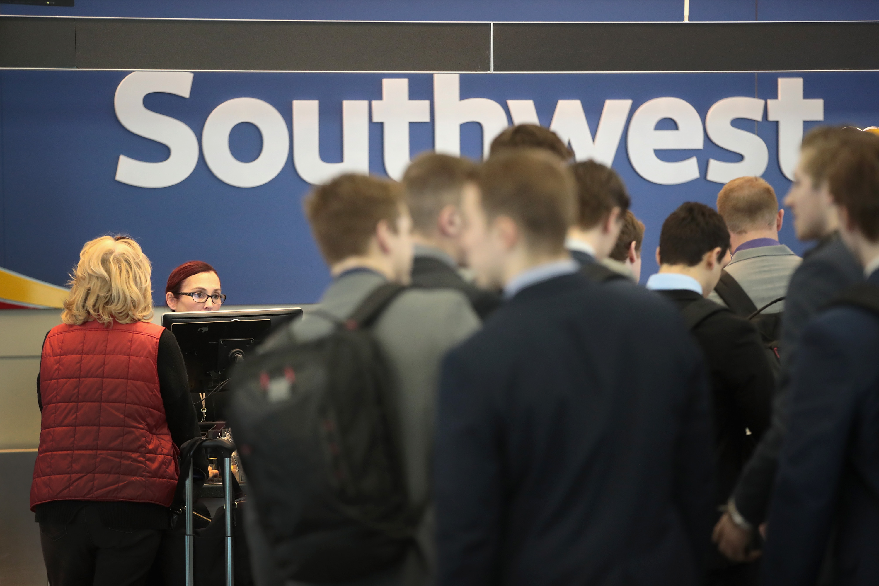 Southwest Airlines passengers check in for flights at Midway Airport on January 25, 2018 in Chicago, Illinois. Southwest Airlines said that fourth-quarter profit jumped to $1.89 billion as the recent changes in the tax law reduced the company's deferred tax liability. The changes are also expected to boost 2018 earnings.