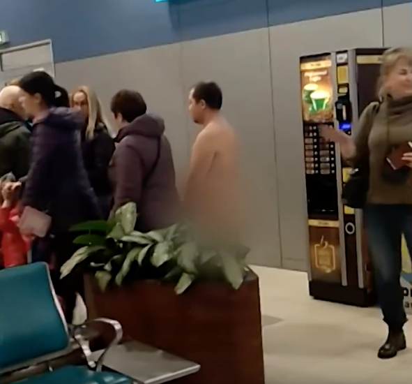 The man was detained by police after stripping naked in the airport (Source: YouTube)