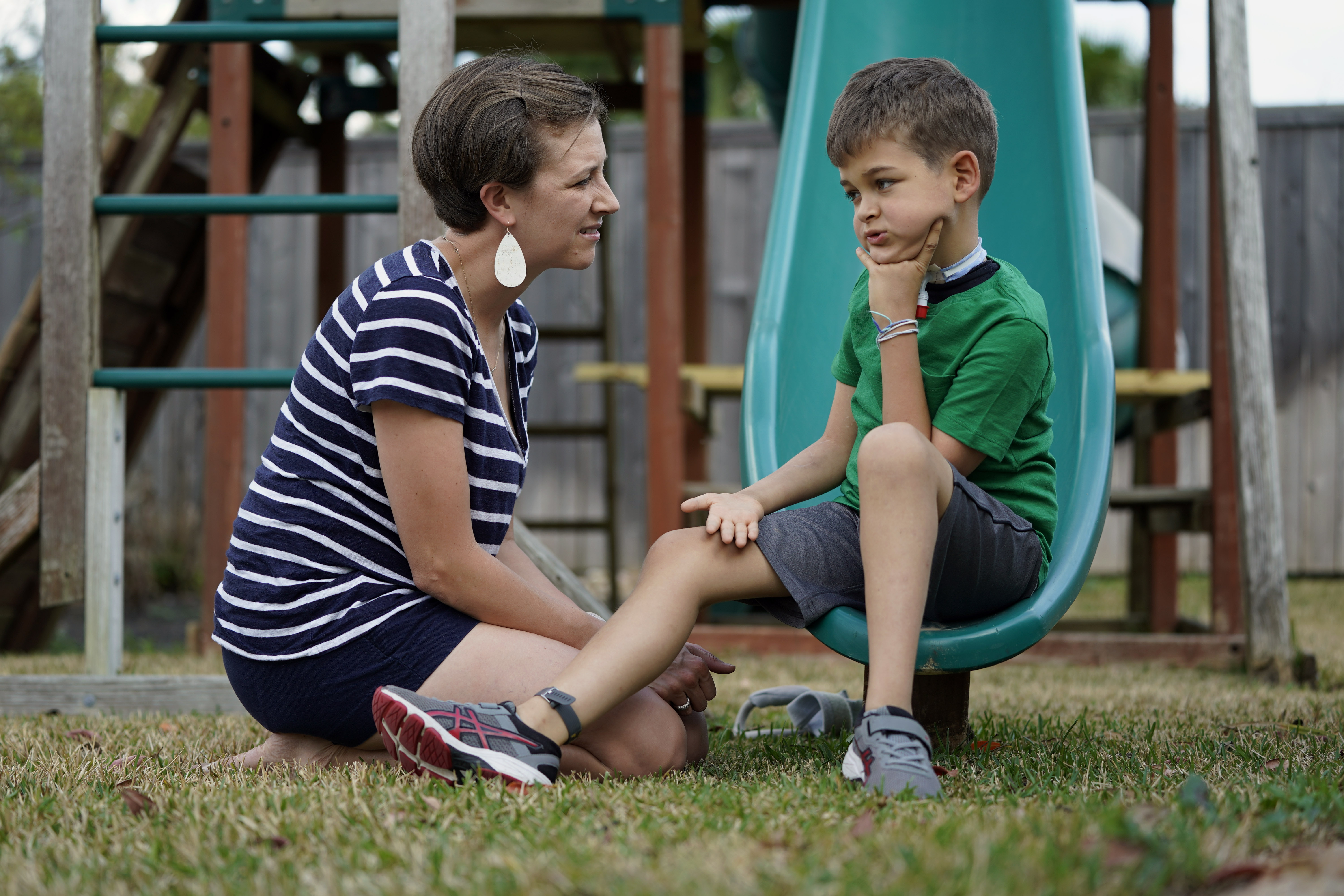 Rachel Scott, left, talks with her son, Braden, in Tomball, Texas on Friday, March 29, 2019. “Everyone is desperate for some magical thing” to cure the kids, said Rachel. Braden developed acute flaccid myelitis, or AFM, in 2016. (AP Photo/David J. Phillip)