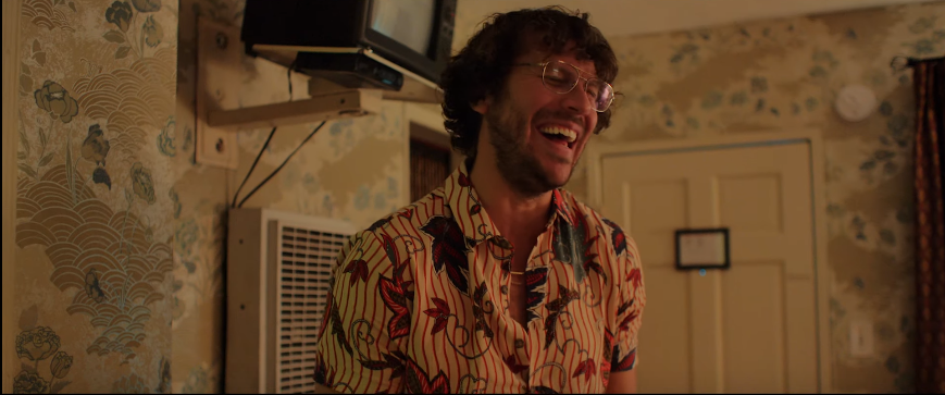 We get introduced to MacArthur's character, Chester, through his classic no-nonsense facade, where he ends up breaking into a menacing laugh which is enough to raise the alarm that this is no stereotypical white dude 'trying to crack a few laughs'. Source: YouTube screenshot