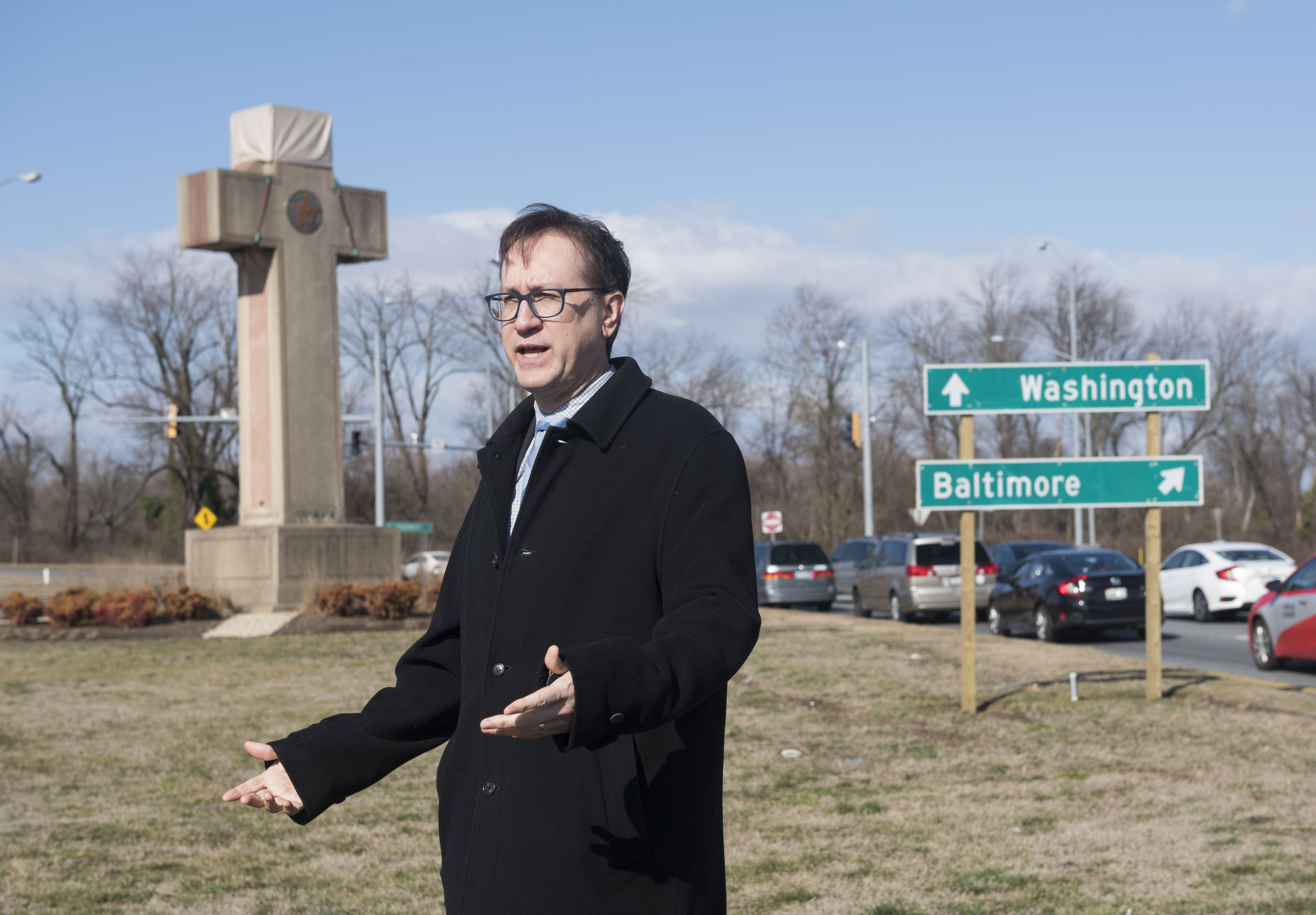 Roy Speckhardt, executive director of the American Humanist Association, speaks near the 40' Maryland Peace Cross dedicated to World War I soldiers on Wednesday, Feb. 13, 2019 in Bladensburg, Md. (AP Photo/Kevin Wolf)