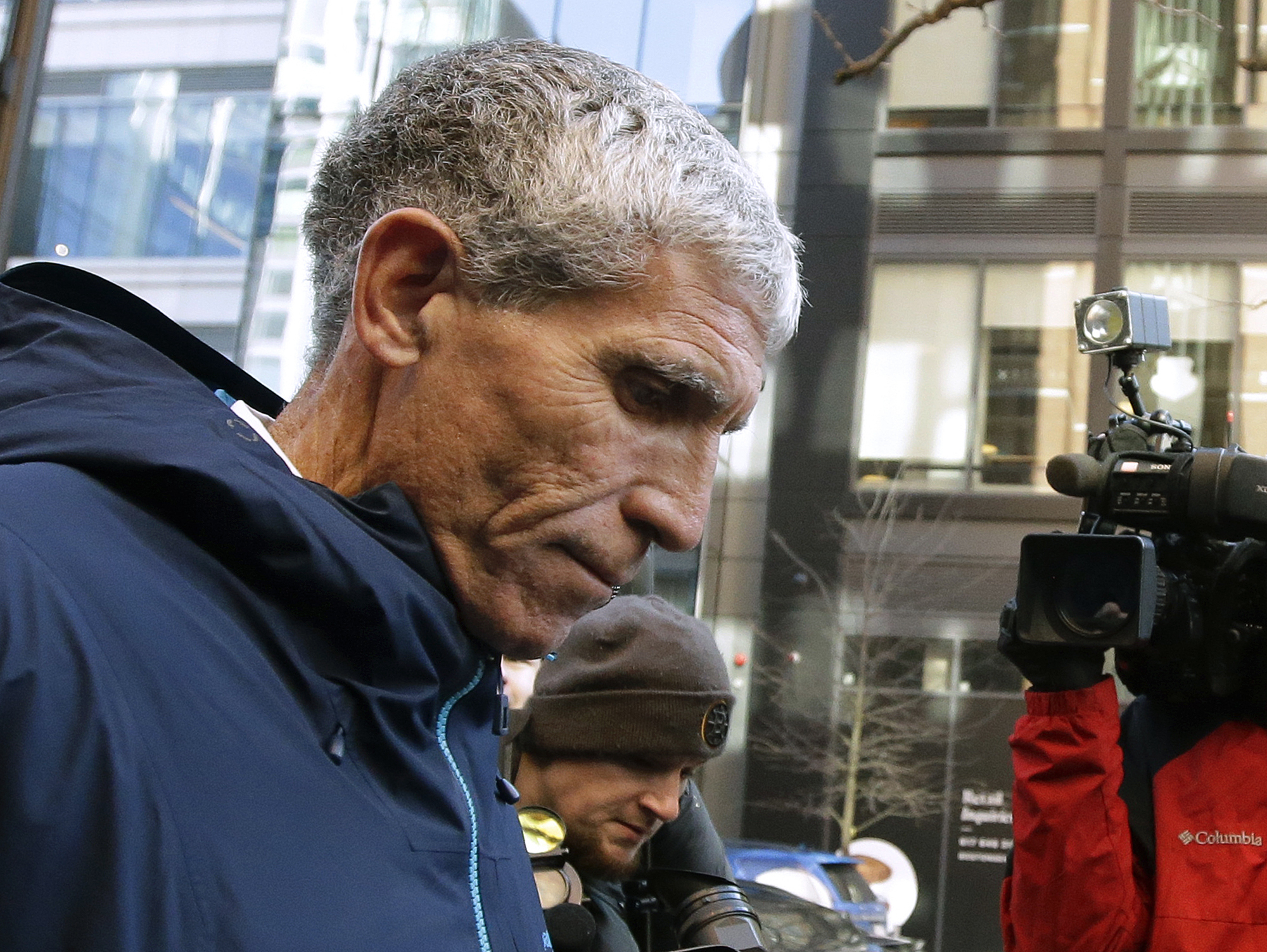 In this March 12, 2019, file photo, William "Rick" Singer founder of the Edge College & Career Network, departs federal court in Boston after pleading guilty to charges in a nationwide college admissions bribery scandal. Prosecutors allege Singer funneled millions of dollars from parents through his tax-exempt organization and then used it to pay coaches and other insiders to designate their children as athletic recruits or cheat on entrance exams, (AP Photo/Steven Senne, File)