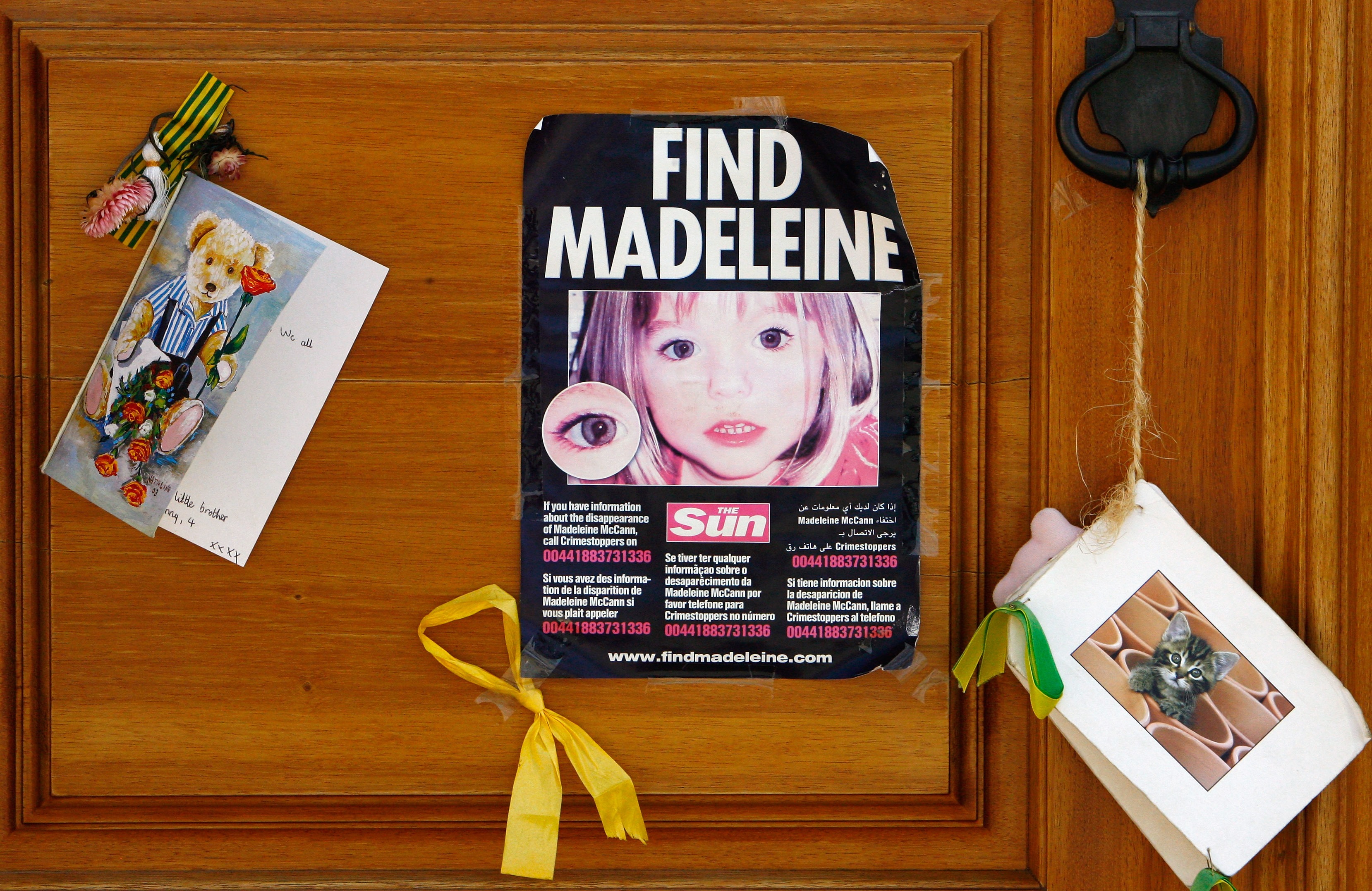 A poster and cards are placed on the Church door in Praia da Luz for missing Madeleine McCann August 9, 2007 in Praia da Luz, Portugal. Police continue there investigation in the Algarve village after blood was found in the McCann Apartment. (Getty Images)