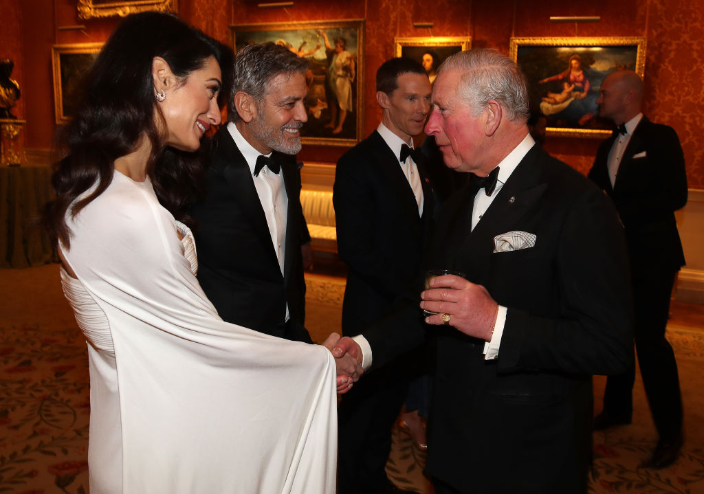 Amal Clooney and George Clooney speak to Prince Charles, Prince of Wales, as they attend a dinner to celebrate The Prince's Trust, hosted by Prince Charles at Buckingham Palace on March 12, 2019, in London, England. (Photo by Chris Jackson - WPA Pool/Getty Images)