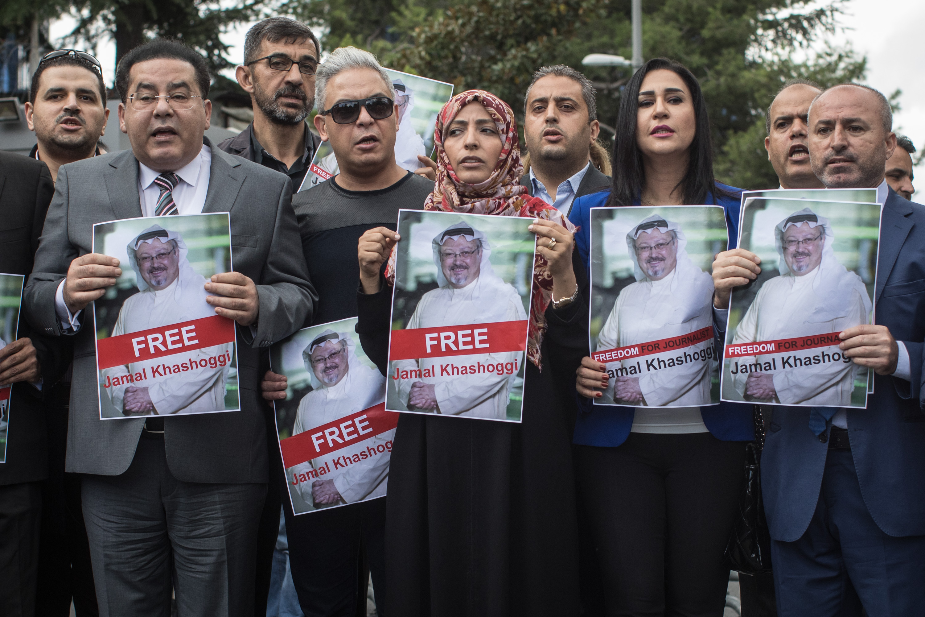 Nobel Prize winner Tawakkol Karman (5th-L) holds a poster of Saudi journalist Jamal Khashoggi during a protest outside Saudi Arabia's consulate on October 8, 2018 in Istanbul, Turkey.