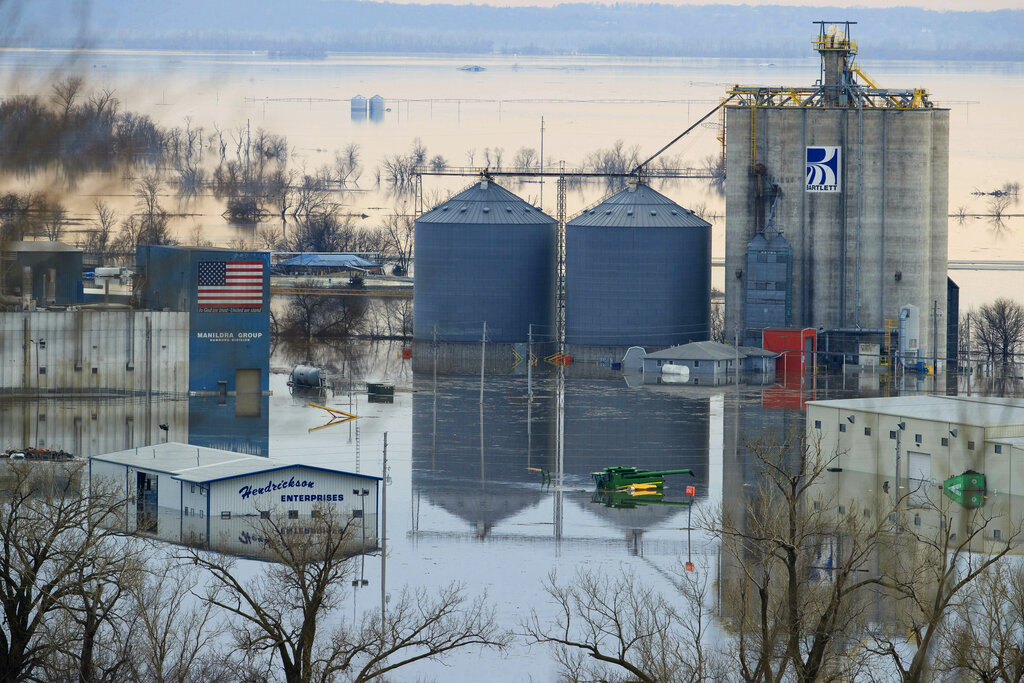 Floodwaters surround buildings on the southwest side of Hamburg, Iowa, Sunday, March 17, 2019 (AP)