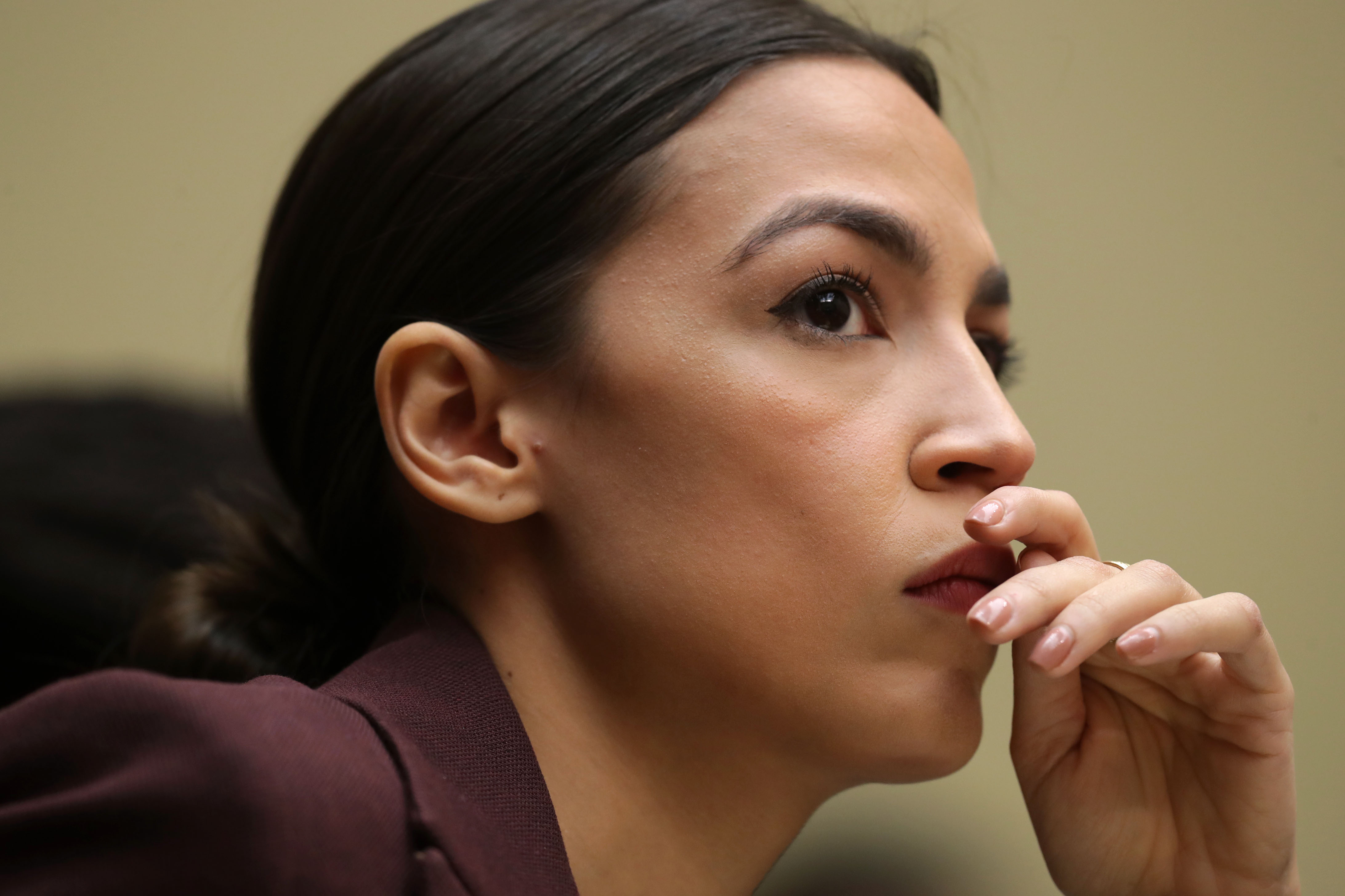 Rep. Alexandria Ocasio-Cortez (D-NY) listens to testimony by Michael Cohen, former attorney and fixer for President Donald Trump, before the House Oversight Committee on Capitol Hill February 27, 2019 in Washington, DC. (Source: Getty Images)