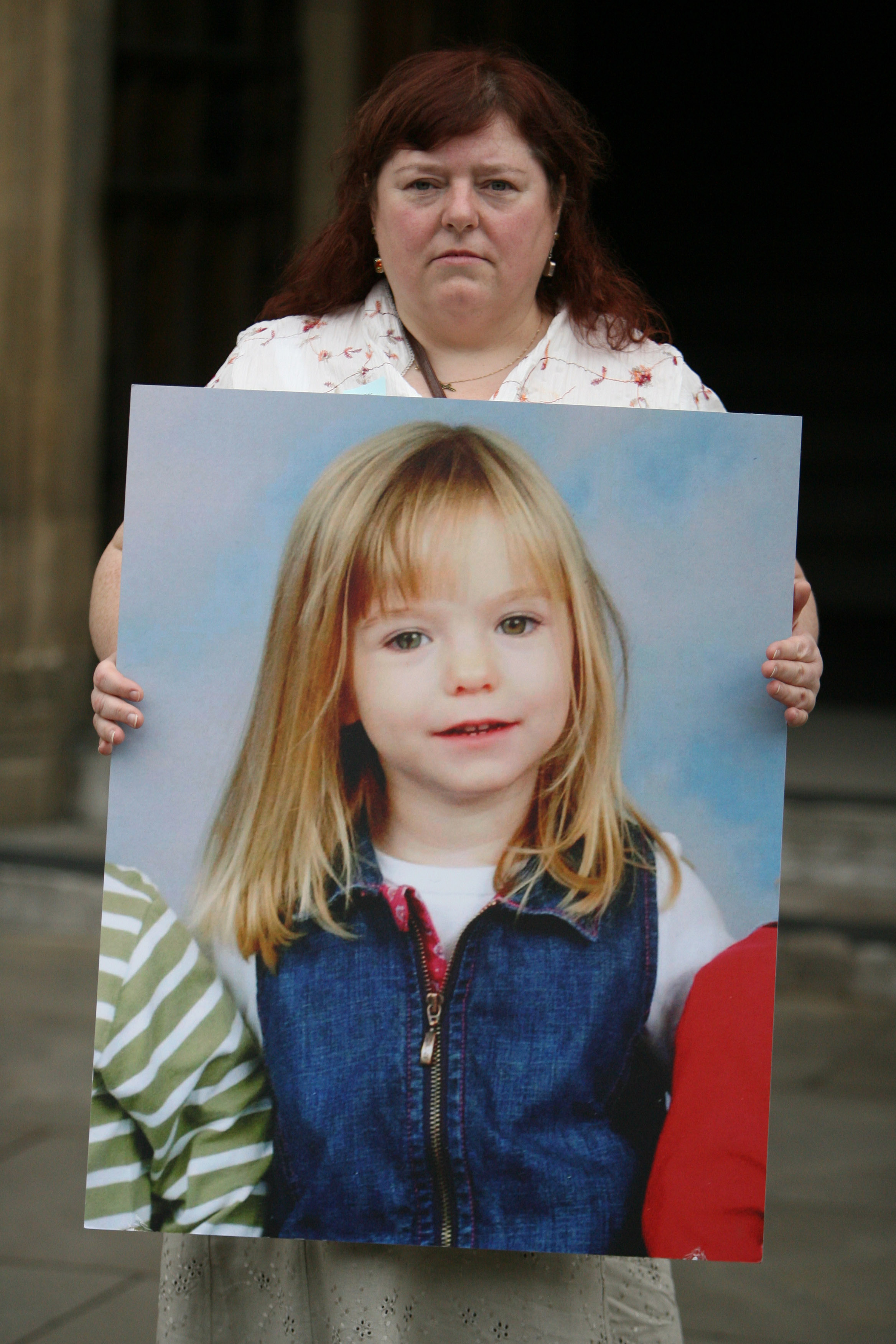 Phil McCann carries a picture of her missing niece Madeleine McCann as she visits Parliament on May 16, 2007 in London. Madeleine McCann disappeared from a holiday complex in Praia da Luz 13 days ago.