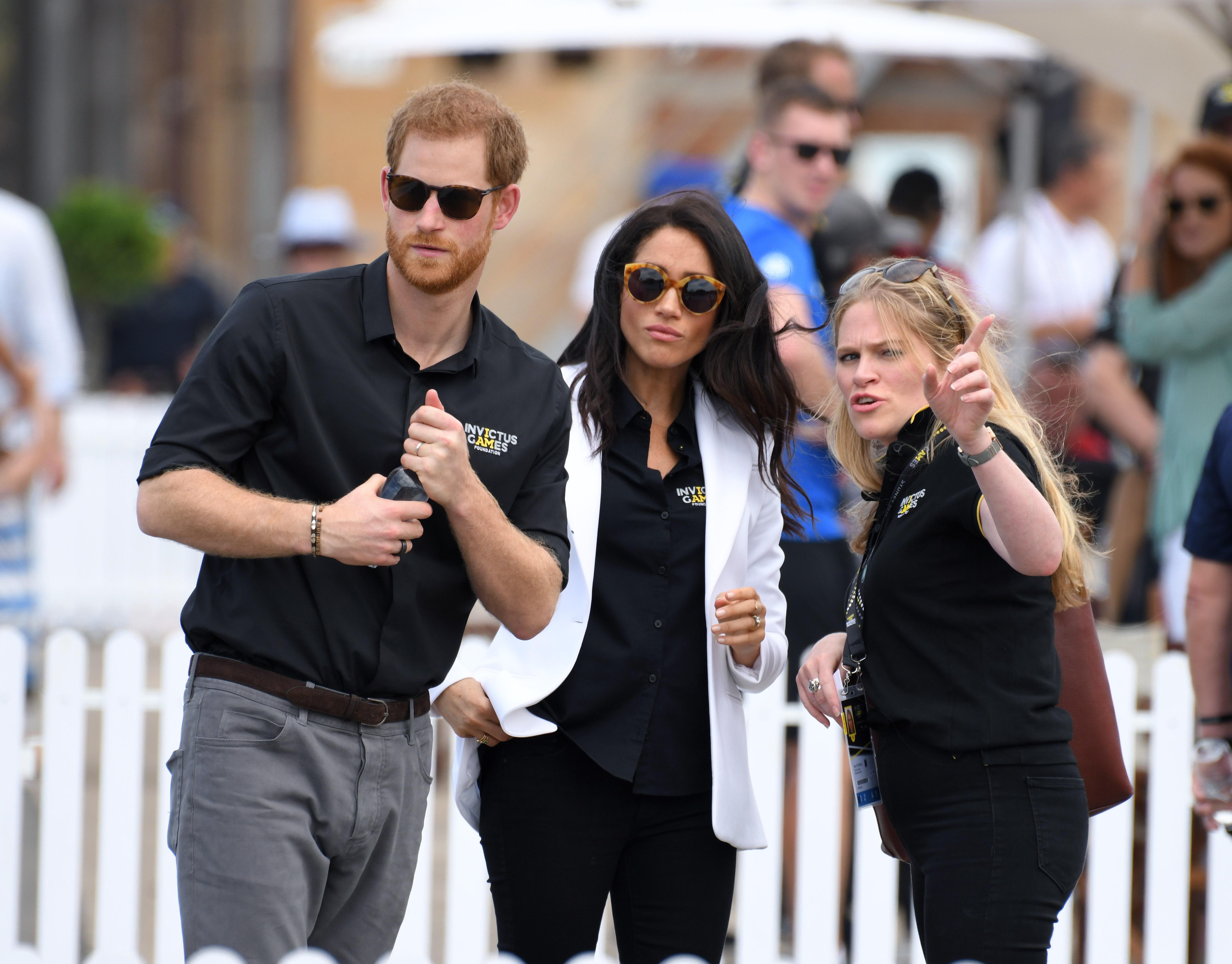 Prince Harry, Duke of Sussex with Meghan, Duchess of Sussex and her assistant Amy Pickerill (R) attend the Invictus Games Sydney 2018 Jaguar Land Rover Driving Challenge on Cockatoo Island on October 20, 2018 in Sydney, Australia. (Photo by Karwai Tang/WireImage)