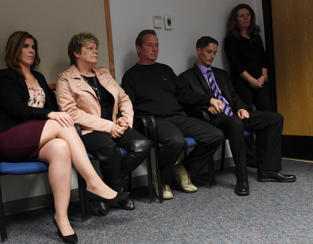 Second from left, Sandra Onorati Rzucek, Frank Rzucek, the mother and father of Shanann Watts, and her brother Frankie Rzucek hold hands as they listen to the Weld County District Attorney, Michael J. Rourke, during a press conference, at the Weld County Courthouse on November 6 (Source: RJ Sangosti/The Denver Post via Getty Images)