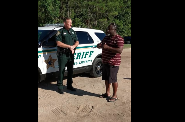 The man can be seen talking to the cops in the picture.
