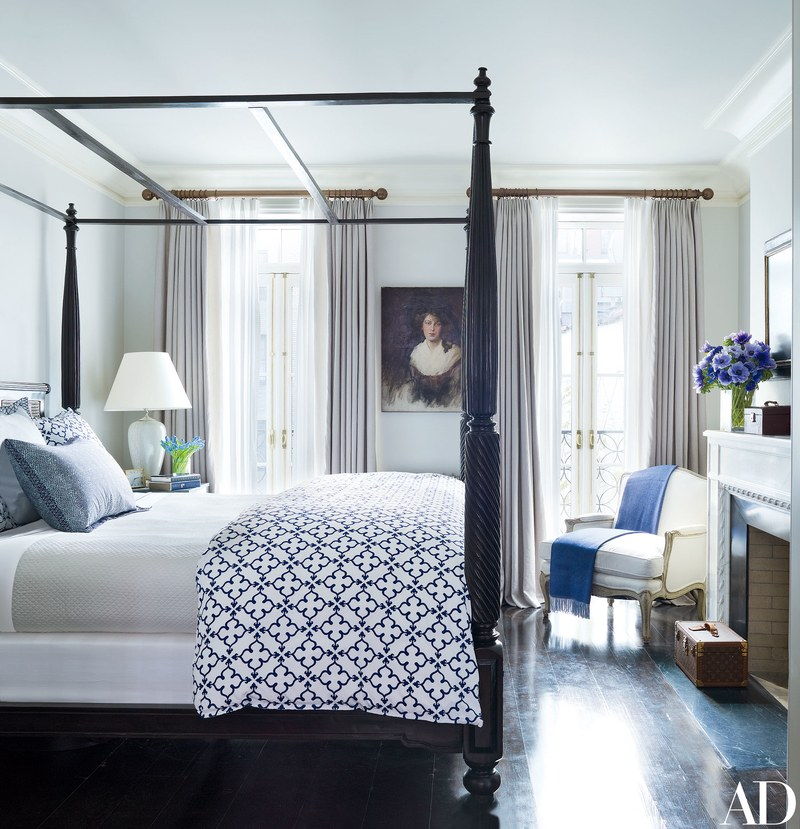 In the master bedroom, an Anglo-Indian tester bed is dressed in John Robshaw block-printed linens. The oil portrait is Edwardian and was purchased in London; a throw from the Silver Peacock drapes the 19th-century armchair.