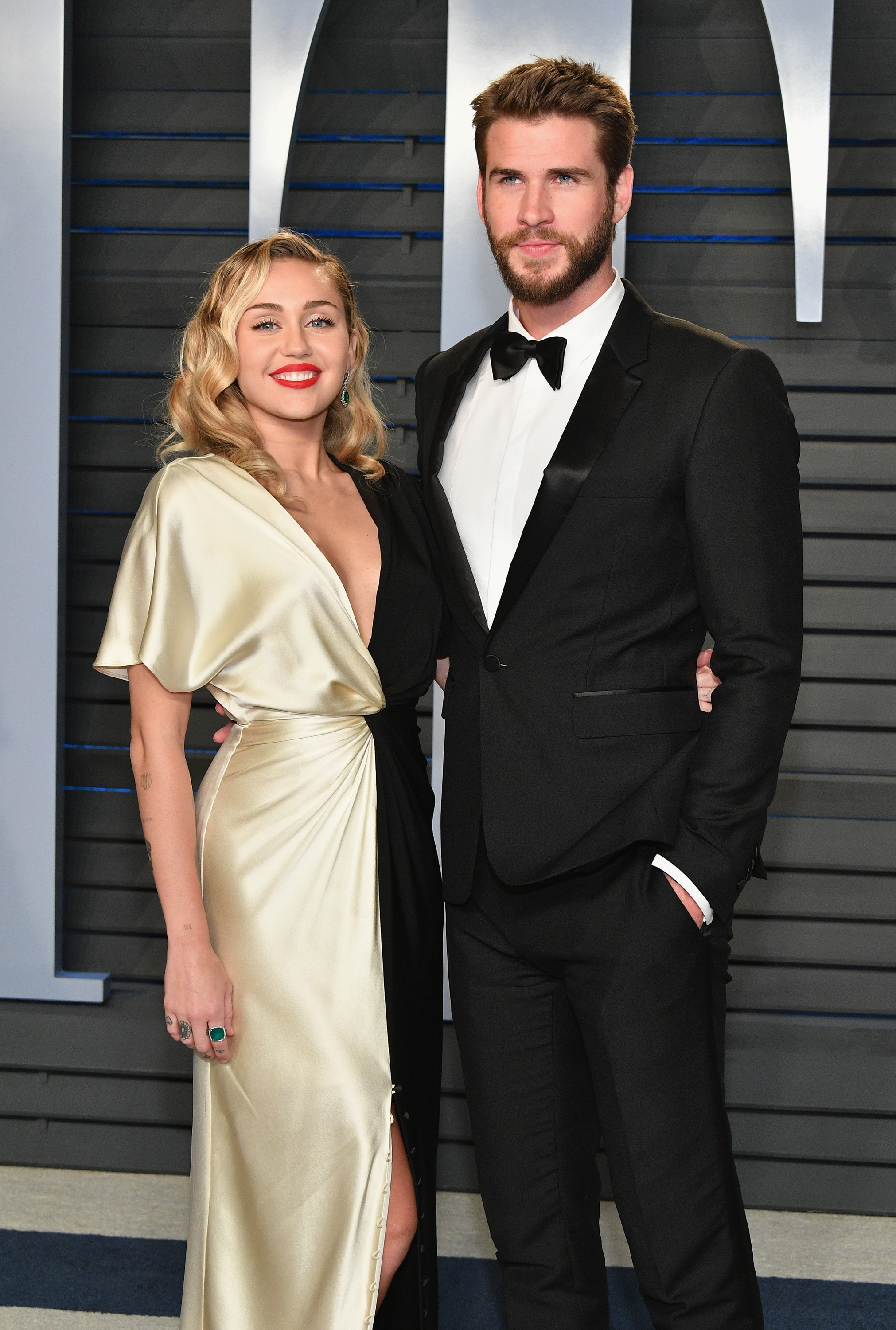 Miley Cyrus (L) and Liam Hemsworth attend the 2018 Vanity Fair Oscar Party hosted by Radhika Jones at Wallis Annenberg Center for the Performing Arts on March 4, 2018 in Beverly Hills, California.