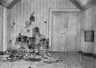 The basement where the Romanov family was killed. The wall had been torn apart in search of bullets and other evidence by investigators in 1919. The double doors leading to a storeroom were locked during the execution. (Wikipedia)