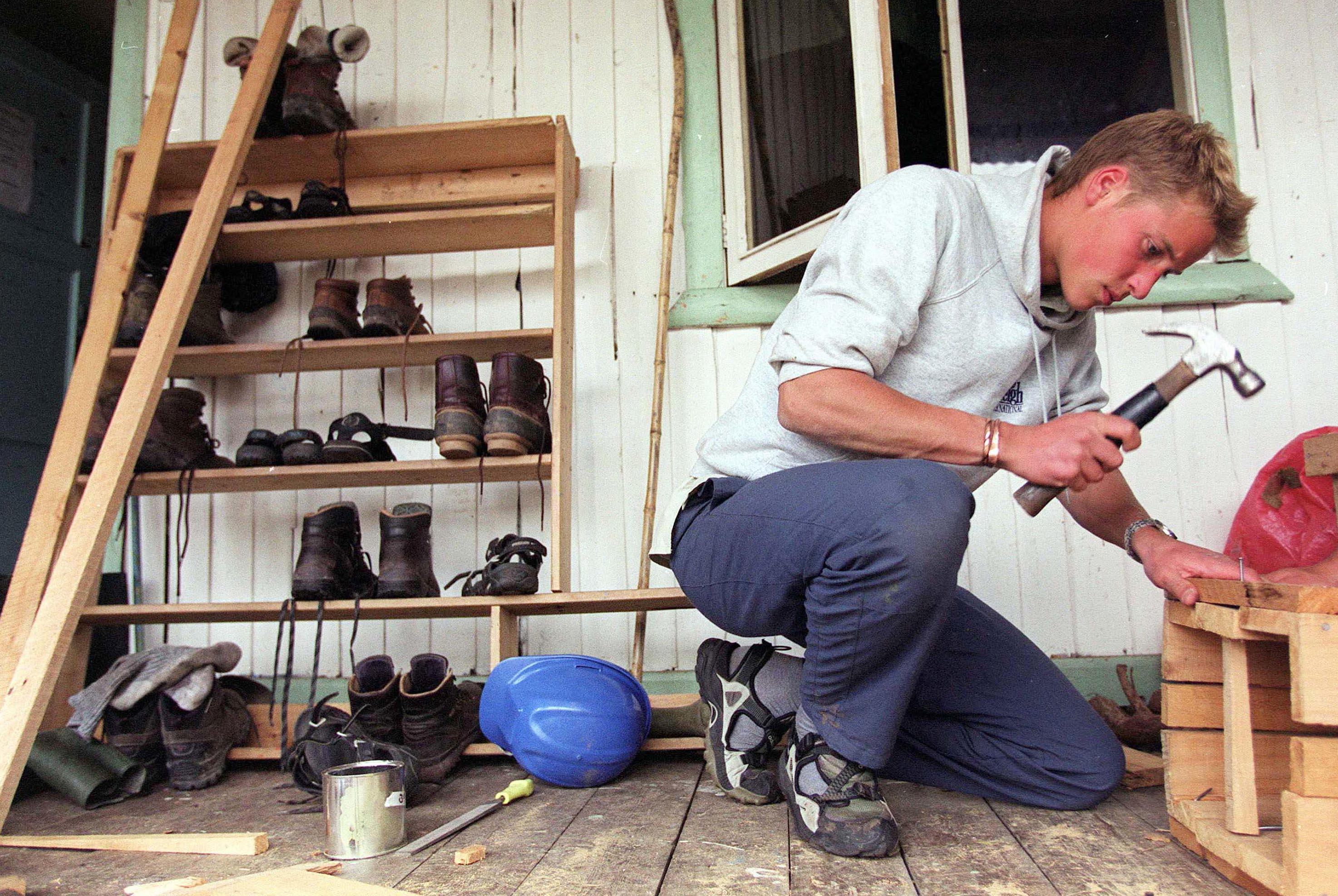 Prince William makes a wooden rubbish bin for villagers at the team''s accommodations December 7, 2000 in Tortel, Southern Chile during his Raleigh International expedition