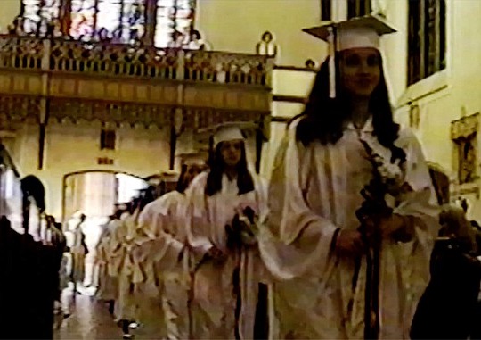 Meghan walking down the school's church aisle at her graduation.