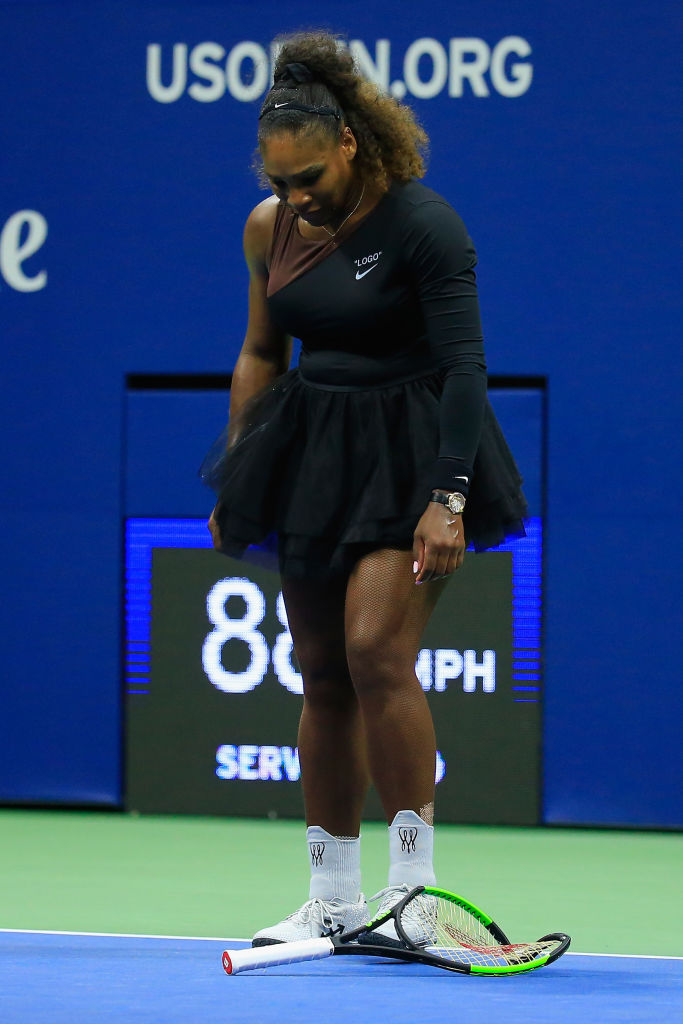 Serena Williams of the United States looks on after smashing her racket during her Women's Singles finals match against Naomi Osaka of Japan on Day Thirteen of the 2018 US Open. (Photo by Chris Trotman/Getty Images for USTA)