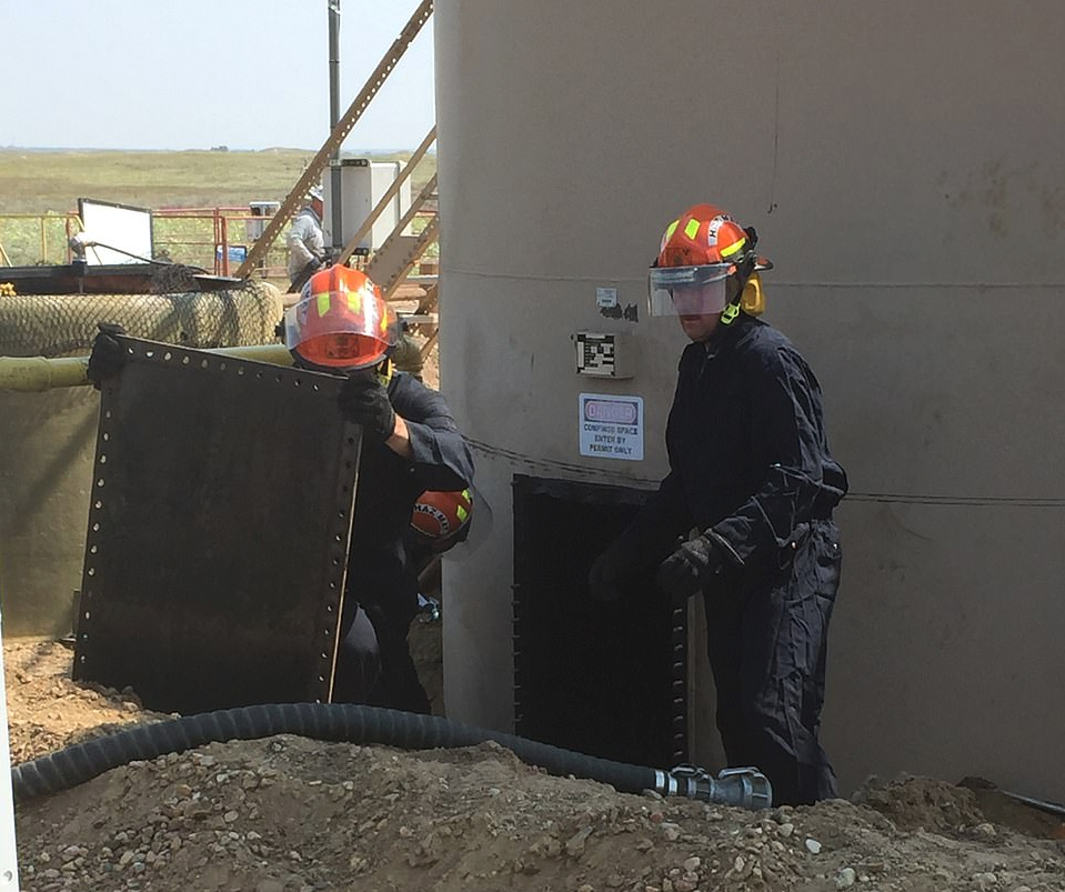 The oil stored in the 400-barrel tanks at the remote oil site owned by Anadarko Petroleum was manually drained by workers who carefully poured the liquid over metal screens to collect any evidence. (Source: Weld County DA)