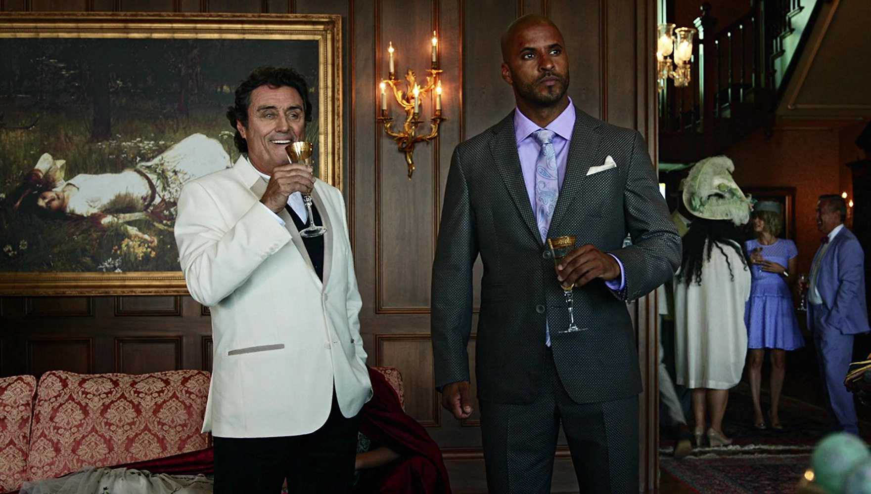 Mr. Wednesday (Ian McShane) and Shadow Moon (Ricky Whittle) visiting Easter's (Kristin Chenoweth) party in 'American Gods'.
(Source: IMDB)