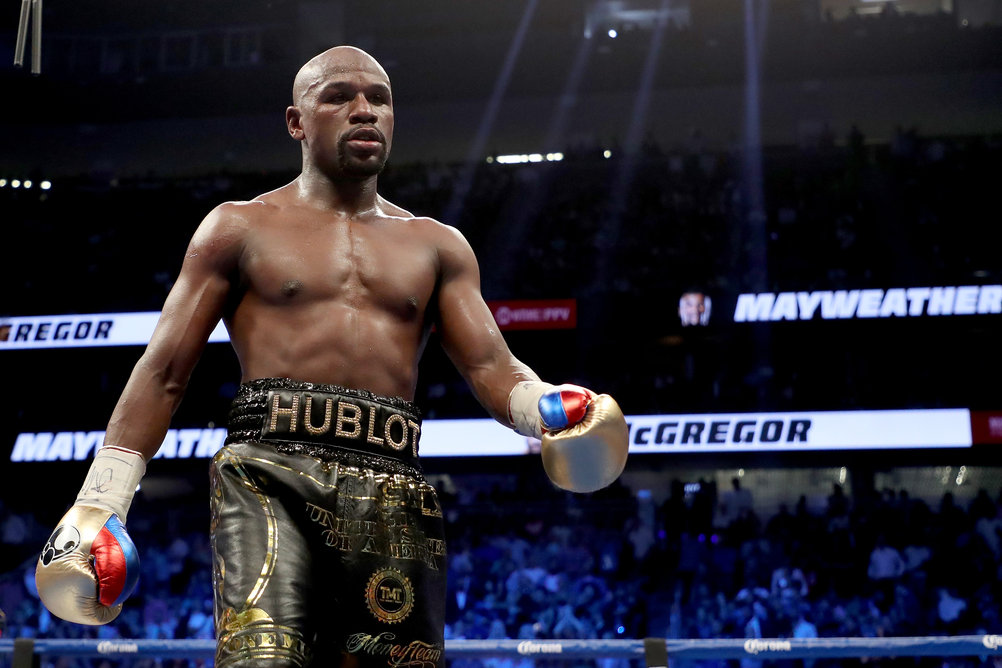 Floyd Mayweather Jr. walks to his corner while taking on Conor McGregor during their super welterweight boxing match on August 26, 2017 at T-Mobile Arena in Las Vegas, Nevada.